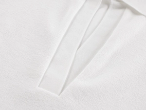Detailed close-up of a white polo shirt neck showing fine knit fabric texture