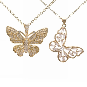 Golden butterfly pendant necklaces with glittering clear crystals on a white background