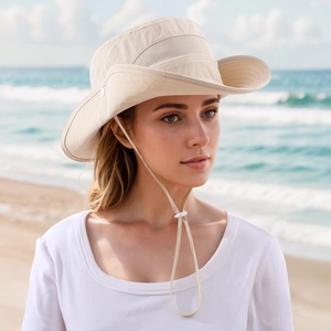 Detail of beige outdoor sun hat with breathable mesh side and adjustable chin strap