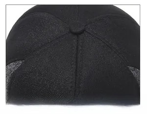 Macro shot of 6-panel crown stitching and top button on a winter baseball cap