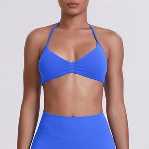 Detail of royal blue halter neck sports bra and high-waisted leggings set in studio lighting
