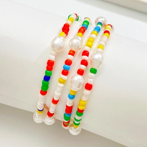 Bohemian colorful handmade beaded bracelet set with faux pearls on white stand