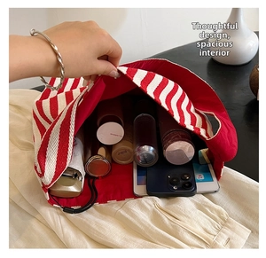 Macro shot of large capacity red striped tote bag showing spacious red lined interior
