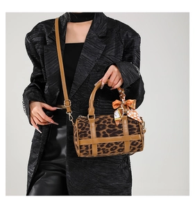 Detail of leopard print Boston barrel bag with khaki leather trim and silk scarf