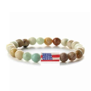 Detail of beaded bracelet with American flag charm and natural turquoise agate stones