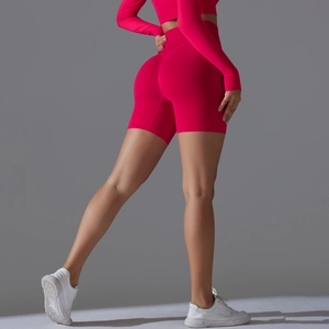 Rear view of rose red seamless high-waist yoga shorts showing peach lift effect