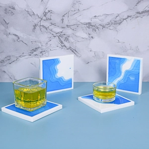 Macro shot of square resin coaster featuring artistic blue and white ocean wave patterns