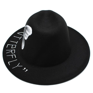 Detail of black wool fedora featuring white Butterfly printed text on wide brim
