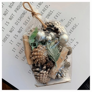 DIY Christmas kit with pine cones, cinnamon sticks and silver ornaments in a rustic pouch