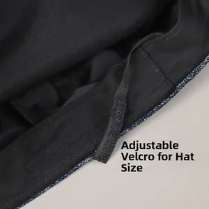 Detail view of denim navy hat interior showing adjustable velcro strap for size control