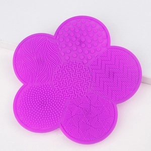 Detailed view of purple flower silicone brush cleaner with various textured cleaning zones
