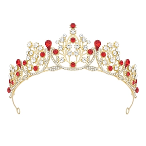 Baroque gold crown with red teardrop gems and white crystals on a white background