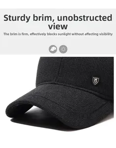 Detail of a black winter baseball cap showing the sturdy brim and textured knit fabric