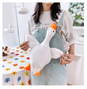 Cute white goose plush crossbody bag with orange beak and soft wings on a model