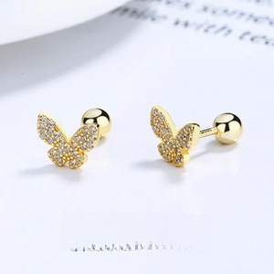 Macro view of gold butterfly stud earrings with zircon inlay and screw ball back