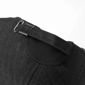 Detail of the adjustable metal buckle and ribbed knit strap on back of black winter cap