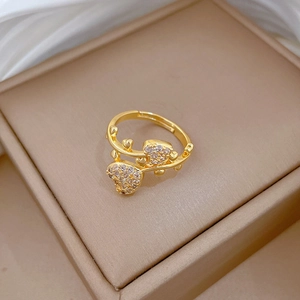 Detailed macro shot of a gold heart ring with pavé zircons on a beige gift box
