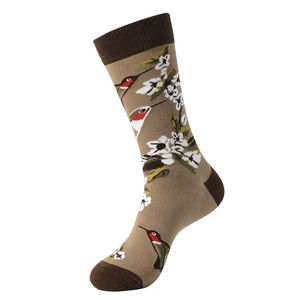 Detailed knit of khaki crew sock featuring hummingbirds and white floral embroidery