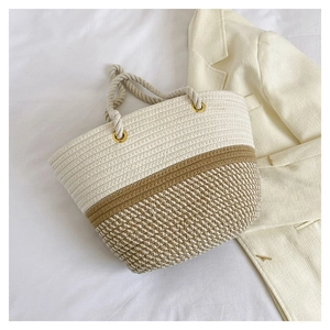 Close-up of dual-tone woven tote bag with cotton rope material and metal eyelet detail