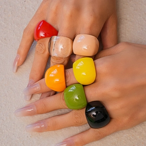 Colorful chunky acrylic resin square rings shown layered on hands for a stylish look