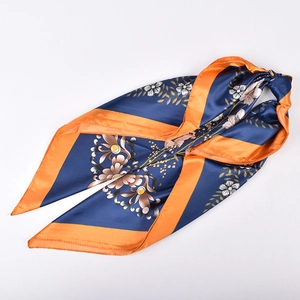 Close-up of floral print satin square scarf with navy base and orange border