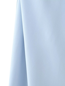 Detailed macro view of light blue satin fabric texture and premium silky drape