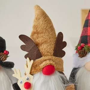 Three plush Christmas gnomes with reindeer antlers and pine cones for festive holiday decor