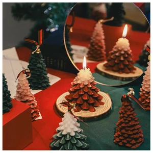Detailed view of handcrafted Christmas tree scented candles on rustic wooden bases