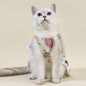Detailed view of lightweight summer pet dress with floral prints on a white cat