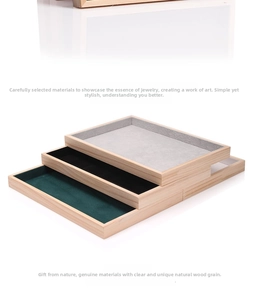 Detailed view of three stackable solid wood jewelry trays with colorful velvet lining