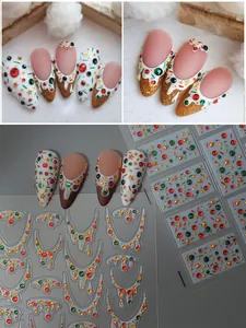 Macro detail of 3D Christmas nail stickers with red green gems and gold stars
