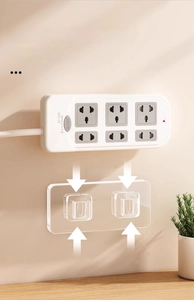 Self-adhesive power strip wall mount holder with a 6-outlet power board on beige wall
