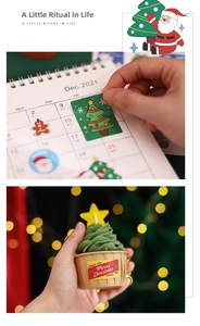 Detailed view of Christmas stickers on calendar and cupcakes with warm festive bokeh lighting