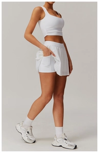 Detail view of white pleated sports skirt with built-in side pocket for phone and essentials