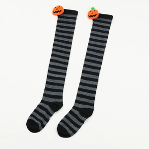 Detail of Halloween over-knee socks with black-grey stripes and 3D orange pumpkin decor