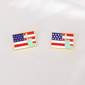 Detail view of rectangular US flag enamel studs with Statue of Liberty on white silk