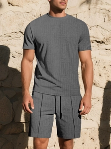 Detail of grey men's summer set with textured geometric knit fabric and drawstring shorts