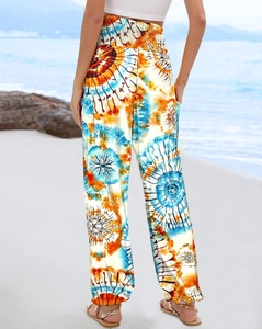Back view of high-waisted wide-leg floral pants with elastic waistband on beach