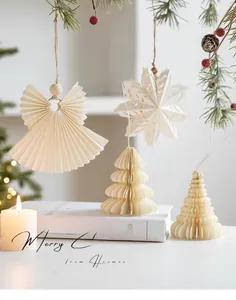 Detail of cream white honeycomb paper Christmas ornaments with wood beads and rustic rope