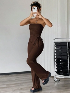 Deep brown two-piece set featuring a ruched tube top and high-waisted flared trousers
