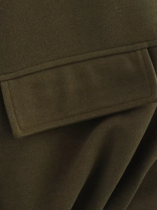 Close-up of olive green heavy fabric showing twill texture and neat reinforced stitching