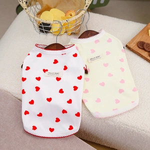 Detail of breathable heart print dog vests in white and yellow with soft wavy edges