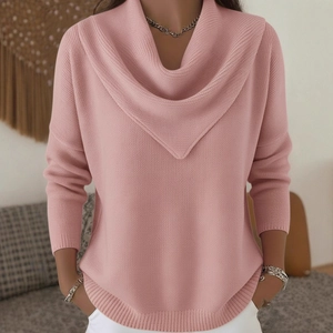 Cozy pink cowl neck knit sweater with drop shoulders shown in a home setting