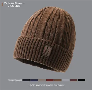 Close-up of yellow-brown cable knit winter hat with leather patch and warm fleece lining