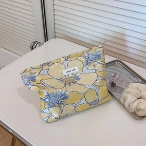 Elegant floral makeup bag with yellow flower patterns and simple wish woven label