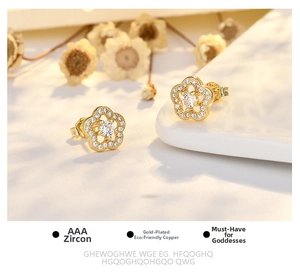 Detailed macro view of gold plated copper plum blossom earrings with AAA cubic zirconia