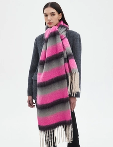 Detail of pink and grey striped plush scarf with soft fringe tassels on grey blazer