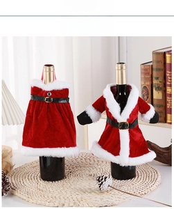 Detail of red velvet Christmas wine bottle covers with white fur trim and belt accents