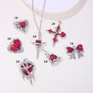 Red gemstone and silver metal Gothic charms set with heart, cross, and wings