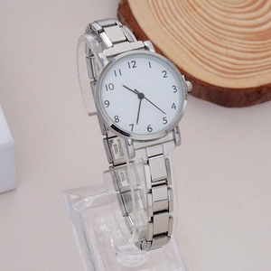 Detail of a silver metal watch band with Stainless Steel engraved on the clasp